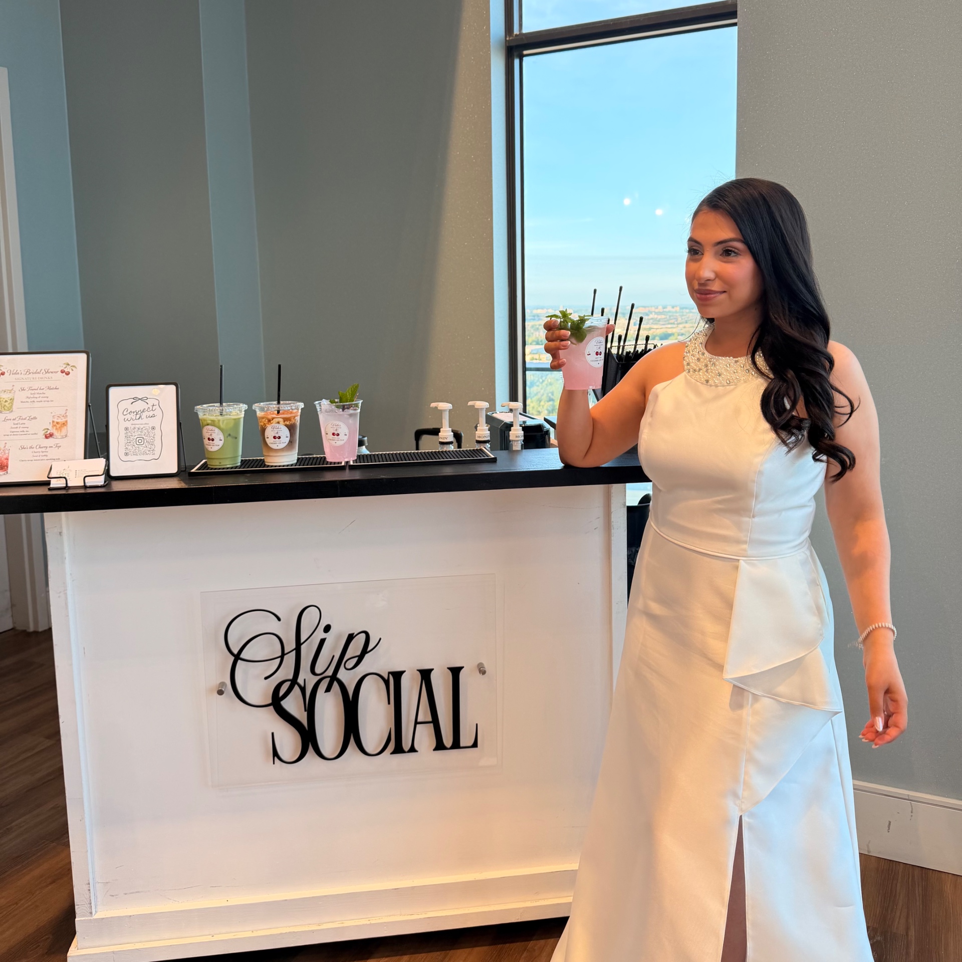 Bride at the Sip Social bar with signature drinks
